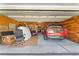 Tidy garage with a red SUV parked inside, showcasing potential for parking and storage at 4551 Hunting Lodge Dr, St Cloud, FL 34772