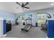 Well-equipped home gym with treadmill, exercise bike, and weightlifting equipment at 4551 Hunting Lodge Dr, St Cloud, FL 34772