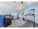 Home gym with treadmill, weights, and office space, illuminated by a window overlooking the yard at 4551 Hunting Lodge Dr, St Cloud, FL 34772