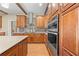 Gourmet kitchen featuring stainless steel appliances, custom cabinetry, and a decorative backsplash at 4551 Hunting Lodge Dr, St Cloud, FL 34772