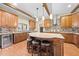 Spacious kitchen featuring a large island with seating, custom cabinetry, and wooden beam accents at 4551 Hunting Lodge Dr, St Cloud, FL 34772