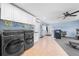 Well-lit laundry area offering modern appliances, storage, and a convenient workspace, with blue accent walls at 4551 Hunting Lodge Dr, St Cloud, FL 34772