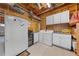 Functional laundry room featuring ample cabinet space, a refrigerator, and a convenient washer and dryer at 4551 Hunting Lodge Dr, St Cloud, FL 34772