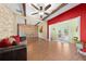 Spacious living room featuring a stone wall, ceiling beams and access to the pool through glass doors at 4551 Hunting Lodge Dr, St Cloud, FL 34772