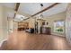 Open-concept living space features hardwood floors, stone walls and an easy flow to the kitchen at 4551 Hunting Lodge Dr, St Cloud, FL 34772