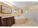 Beautifully designed bathroom with a soaking tub, glass-enclosed shower, and decorative accents at 4551 Hunting Lodge Dr, St Cloud, FL 34772