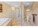 Luxurious bathroom featuring tiled shower with multiple shower heads, soaking tub, and granite vanity at 4551 Hunting Lodge Dr, St Cloud, FL 34772