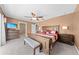 Spacious main bedroom featuring a ceiling fan, en-suite bathroom, and wood furnishings at 4551 Hunting Lodge Dr, St Cloud, FL 34772