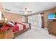 Main bedroom with ceiling fan and balcony access featuring views of backyard and outdoor space at 4551 Hunting Lodge Dr, St Cloud, FL 34772