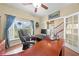 Home office with a large executive desk, hardwood floors and a window with tranquil views at 4551 Hunting Lodge Dr, St Cloud, FL 34772