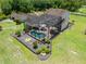 Aerial view of screened pool area with outdoor seating surrounded by landscaped yard at 4551 Hunting Lodge Dr, St Cloud, FL 34772