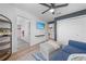 Sitting room with a cozy couch, television, wood-look flooring and easy access to other rooms at 4551 Hunting Lodge Dr, St Cloud, FL 34772