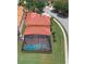 Aerial view of a home with a red tile roof and a screened-in pool, showcasing the property's backyard and outdoor space at 477 Orange Cosmos Blvd, Davenport, FL 33837