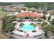Aerial view of a community center with a pool, lounge chairs, and lush landscaping, perfect for relaxation and recreation at 477 Orange Cosmos Blvd, Davenport, FL 33837