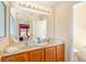 Bright bathroom with double vanity, large mirror, and a separate toilet with shower and bathtub at 477 Orange Cosmos Blvd, Davenport, FL 33837