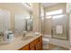Cozy bathroom featuring a vanity, toilet, and shower/tub combo with a glass door and tiled surround at 477 Orange Cosmos Blvd, Davenport, FL 33837