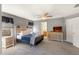 A well lit room features a bed, a dresser and a fan at 477 Orange Cosmos Blvd, Davenport, FL 33837