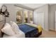 Bright bedroom with a bed featuring a wooden headboard, swan towel art, and natural light streaming through the windows at 477 Orange Cosmos Blvd, Davenport, FL 33837