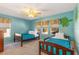 Charming bedroom with twin beds, a tropical-themed wall, and ample natural light at 477 Orange Cosmos Blvd, Davenport, FL 33837