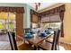 Dining room features wood floors, a modern table setting, and natural light at 477 Orange Cosmos Blvd, Davenport, FL 33837
