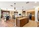 Bright, open kitchen with island, stainless steel appliances, and seamless flow into living and dining areas at 477 Orange Cosmos Blvd, Davenport, FL 33837