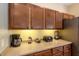 A kitchen counter boasts a coffee maker, toaster, and blender under dark wood cabinets at 477 Orange Cosmos Blvd, Davenport, FL 33837