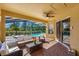 Covered outdoor living space features a ceiling fan, outdoor seating, and a view of the pool at 477 Orange Cosmos Blvd, Davenport, FL 33837