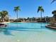 Community pool surrounded by lawn chairs and trees, providing a peaceful setting for relaxation and recreation at 477 Orange Cosmos Blvd, Davenport, FL 33837
