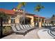 Relax on the pool deck with lounge chairs, palm trees, and beautifully landscaped surroundings at 477 Orange Cosmos Blvd, Davenport, FL 33837