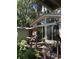 A back porch has a cushioned swing and sliding glass doors, framed by lush foliage at 5019 Pineapple St, Lake Wales, FL 33898