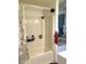 Bathroom featuring a shell-themed shower curtain and vinyl flooring at 5019 Pineapple St, Lake Wales, FL 33898