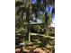 A carport with a blue metal roof sits at the end of a brick driveway lined with tropical foliage at 5019 Pineapple St, Lake Wales, FL 33898