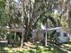 Charming single-story home with a ramp, mature trees, and lush landscaping provides a serene setting at 5019 Pineapple St, Lake Wales, FL 33898