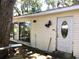 Exterior view of the home with sliding doors and a butterfly wall decoration at 5019 Pineapple St, Lake Wales, FL 33898