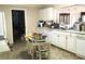 Kitchen featuring white cabinets, appliances, and a dining area at 5019 Pineapple St, Lake Wales, FL 33898