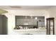 Kitchen with white cabinets and appliances, partially open to another room at 5019 Pineapple St, Lake Wales, FL 33898