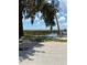 Picturesque lake view featuring an old tree with hanging moss overhanging the water and a pier at 5019 Pineapple St, Lake Wales, FL 33898