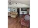 Open living area featuring hardwood floors, ceiling fans, and a view into the kitchen at 5019 Pineapple St, Lake Wales, FL 33898