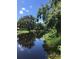 Scenic waterfront view with calm water reflecting the blue sky and lush trees on the banks at 5019 Pineapple St, Lake Wales, FL 33898