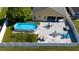 Aerial view showcasing a home with a pool, covered patio, and white privacy fence at 5100 Violet Ln, Kissimmee, FL 34758