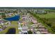A high angle, bird's eye view of a residential community surrounded by ponds and lush greenery at 5100 Violet Ln, Kissimmee, FL 34758