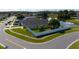 Aerial view of home with green lawn, white fence, and a nearby pond at 5100 Violet Ln, Kissimmee, FL 34758