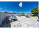 Spacious backyard patio with an outdoor dining table, lounge chairs, and a well-manicured lawn at 5100 Violet Ln, Kissimmee, FL 34758