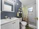 Bathroom featuring a white vanity with a shower-tub combo with a floral curtain at 5100 Violet Ln, Kissimmee, FL 34758
