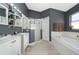 Bathroom boasts a double vanity, tub, and glass-enclosed shower; features neutral tile at 5100 Violet Ln, Kissimmee, FL 34758