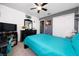 Cozy bedroom features a ceiling fan, dresser with mirror, and ample closet space at 5100 Violet Ln, Kissimmee, FL 34758
