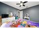 Comfortable bedroom with ceiling fan, neutral paint, and ample natural light at 5100 Violet Ln, Kissimmee, FL 34758
