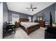 Spacious bedroom with ceiling fan, neutral paint, and wooden furnishings at 5100 Violet Ln, Kissimmee, FL 34758