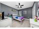 Bedroom with desk, ceiling fan, neutral paint, and white trim at 5100 Violet Ln, Kissimmee, FL 34758