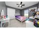 Bedroom featuring tile floors, a ceiling fan, and a large window at 5100 Violet Ln, Kissimmee, FL 34758